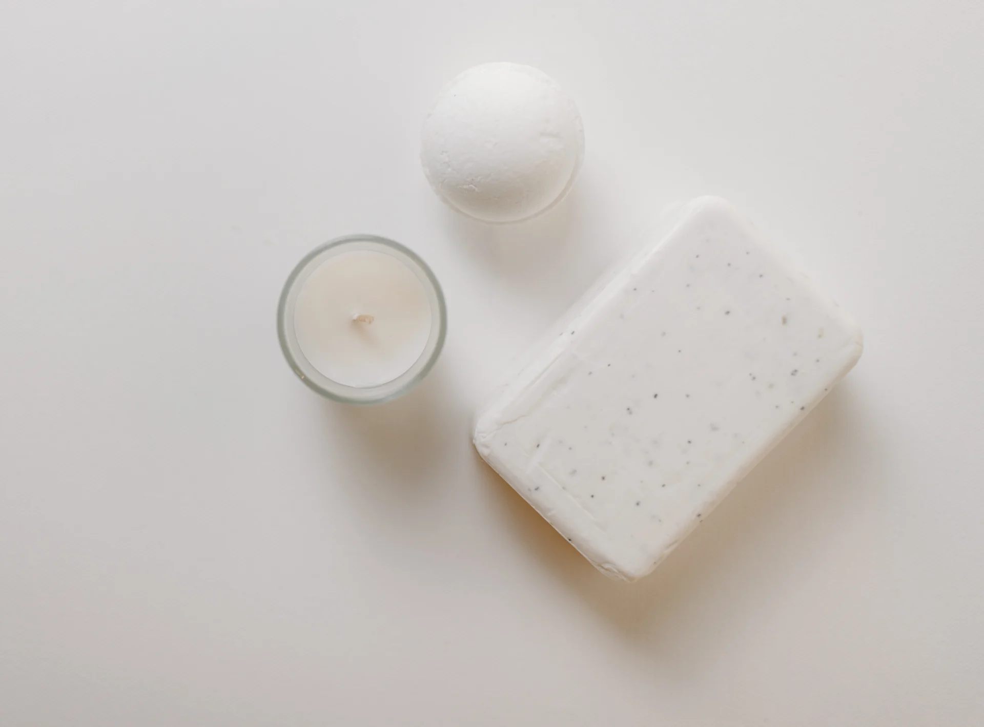 top view of a white soap bar and candle
